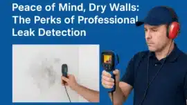 Plumber using thermal imaging and moisture meter to detect hidden wall leak in Sydney home.